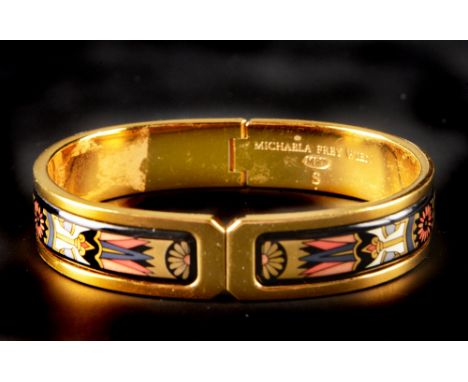 AN ENAMEL AND GILT METAL BANGLE BY MICHAELA FREY, of hinged oval form, decorated with polychrome enamel panels, inner diamete