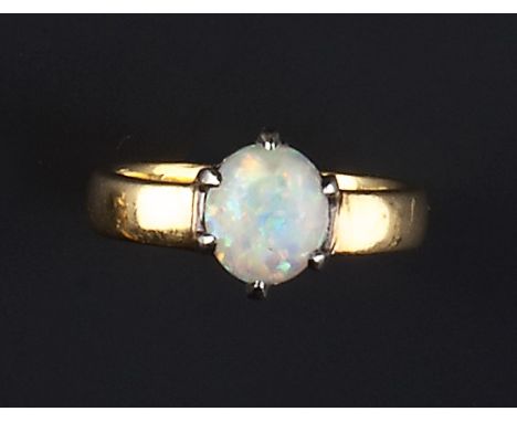 AN OPAL SINGLE STONE RING, the oval cabochon opal in six claw setting, to a 22ct gold band, inscribed to interior, ring size 