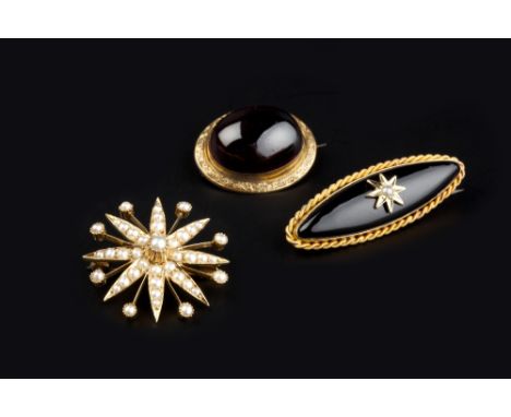 THREE BROOCHES, comprising a half pearl star brooch/pendant, stamped '15ct', an oval cabochon garnet brooch, with foiled clos