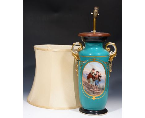 A CONTINENTAL GREEN GROUND PORCELAIN TABLE LAMP decorated figures walking in the Alps, 43cm high ex shade