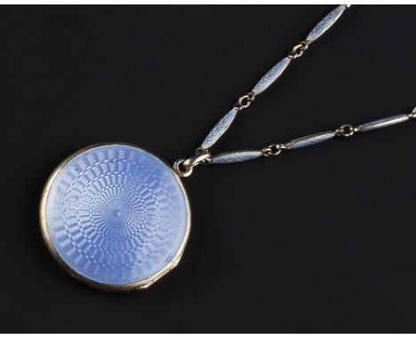 A BLUE ENAMEL LOCKET PENDANT ON CHAIN, the circular locket decorated to both sides with lavender blue guilloche enamel, suspe