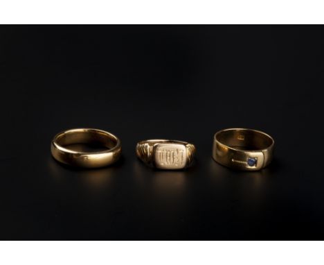 THREE RINGS, comprising a 22ct gold wedding band, inscribed to interior, an 18ct gold signet ring, initialled, and a late Vic