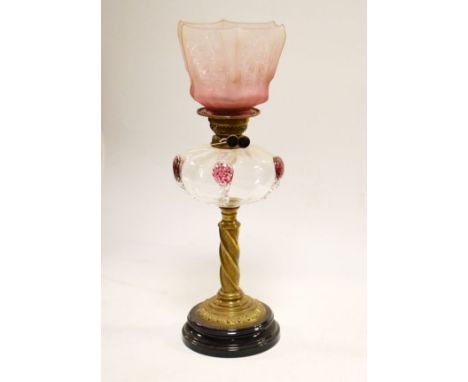 Victorian oil lamp, the clear glass shade with pink flecked glass prunts, brass spiral twist column and black glazed earthenw
