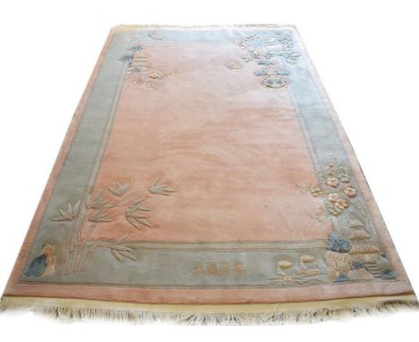 Chinese rug having embossed foliate and architectural decoration and with four Chinese characters to the borders, 313cm x 199