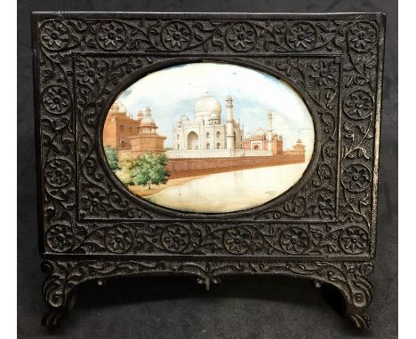 Antique indian painted ivory panel in a highly carved ebony frame oval panel measures approx 10.5cm by 7.5cm  the frame measu