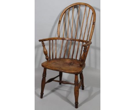 A principally 19thC hoop back high back Windsor chair, with shaped seat, 'C' scroll arms and double ring turned front support