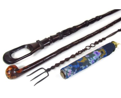 An African tribal staff, with heavily carved pierced cylindrical stem, open top, 87cm high, a knobkerrie style walking stick,