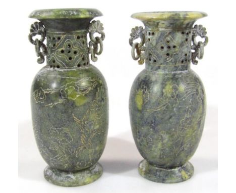 A pair of polished stone jade coloured vases, each with compressed trumpet stems, partially pierced flanked by elaborate hand