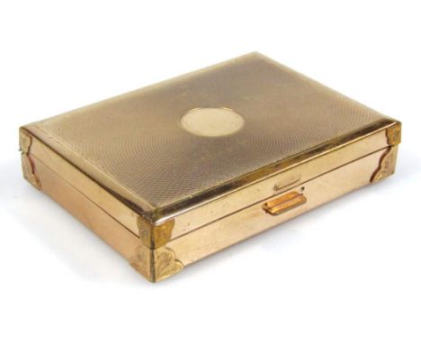 A mid 20thC metal powder compact with musical action, the rectangular engine turned lid with (vacant) circular cartouche with