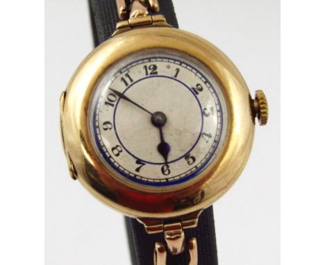 A ladies wristwatch, in a 9ct gold case, on expanding bracelet, the silvered dial with blue enamel design and blue hands, int