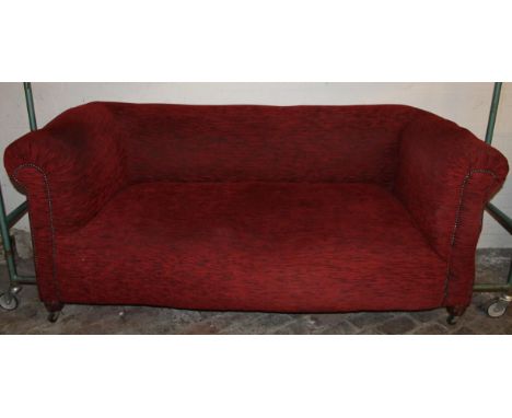 A late 19thC mahogany framed Chesterfield sofa, in (later) red and blue textured material, on compressed supports terminating