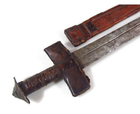 A double edge sword, with leather grip handle and scabbard, with a heavy shaped rounded blade, 83cm wide. 