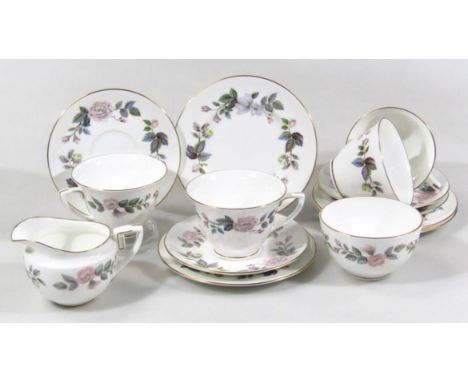 A Royal Worcester June Garland pattern part tea service, comprising of five cups, four saucers and side plates and a milk jug