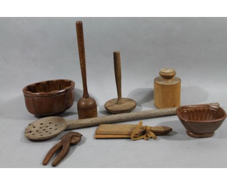 A quantity of rustic treen, to include butter pats 21cm wide, wooden pierced stirring ladle, cosh pie moulds, jelly mould, et