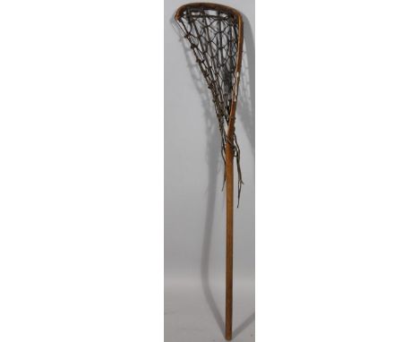 An early 20thC wooden handle lacrosse stick, with webbed netted end, 110cm wide.