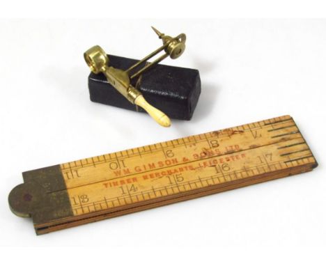 An early 20thC miniature scientific eye glass, with articulated top, inverted ivory handle and arrow pointed to the base, in 