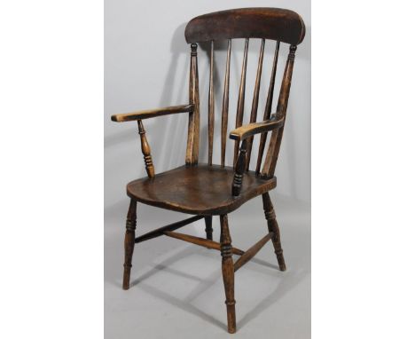 A late 19thC ash and elm comb backed grandfather chair, with spindle back, shaped arms, shaped seat and triple ring turned fr