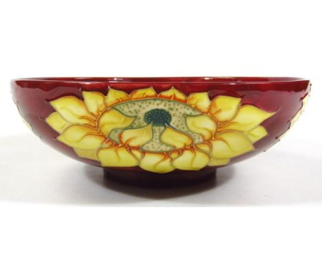 A modern Moorcroft pottery bowl, in the Inca Sunflower pattern, of circular outline on circular foot, impressed and painted m