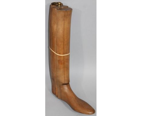 A single polished wooden boot tree or last, with metal ring top, 56cm high. 