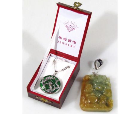 A 20thC Chinese polished jade pendant, raised with figure of Buddha on a naturalistic setting with hook metal top, unmarked, 