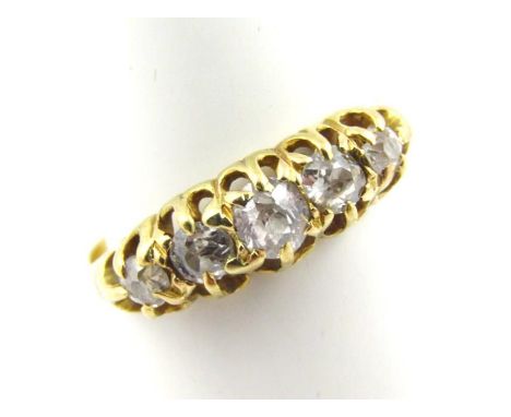 A ladies dress ring, set with five old cut diamonds, on a part pierced shank marked 18ct, size L.