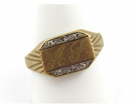 A bi-colour signet ring, of shaped outline, initialled, size Y, marks pitted.