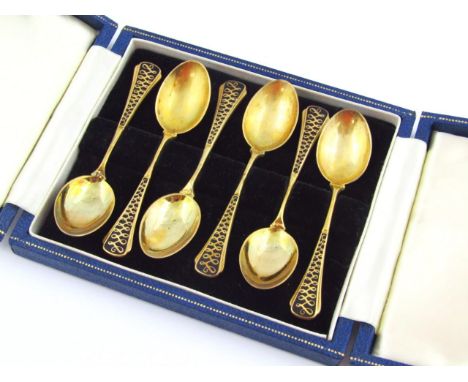 A set of Elizabeth II silver gilt and enamel finish spoons, with shaped tops decorated with a ribbon pattern with plain bowls