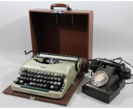 A mid 20thC black telephone, with cord linked hand receiver and front fixed section, partially numbered 332CB, with modern fi