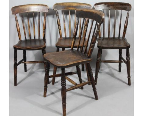 A set of four very late 19thC ash and elm kitchen chairs, with overhanging comb and stick back shaped seats and triple ring t