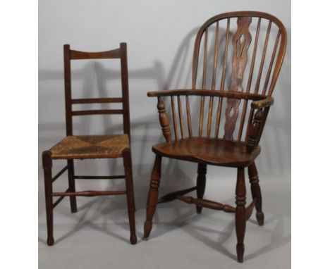 A late 19thC ash and elm high back Windsor chair, with pierced back splat, 'C' shape arm support, shaped seat and double ring