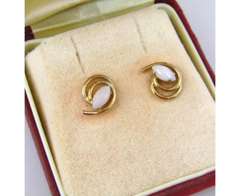 A pair of 9ct gold opal earrings, with a swirl design, with oval shaped opal, boxed. 