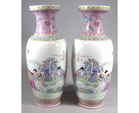 A pair of Chinese porcelain enamel decorated vases, each with trumpet stems and shouldered oval bodies, heavily decorated wit