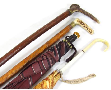 A rustic walking stick, with ram's horn handle and metal tip end, 85cm wide, another horn handled walking stick, heavily carv