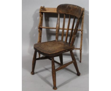 A very late 19thC child's combed back ash and elm chair, with spindle back and shaped seat and plain supports joined by a 'H'