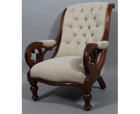A Victorian mahogany scroll armchair, with serpentine back and seat in (later) textured cream button back material, on balust