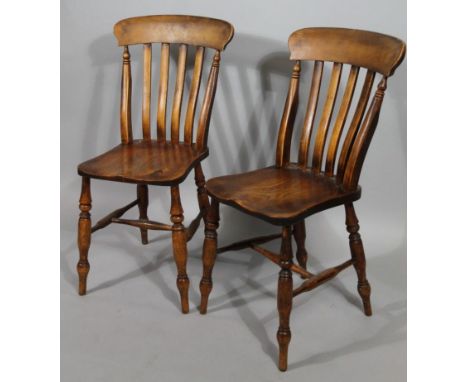 A pair of 19thC ash and elm kitchen chairs, with comb tops, vertical curved splats, shaped seats and single ring turned front