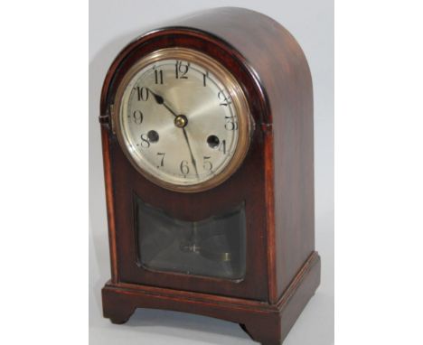 An early 20thC stained oak cased domed top mantel clock, the 11cm dia. Arabic dial fronting a simple pendulum swung key wind 