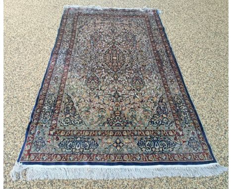 A good quality Persian silk rug with multiple borders, the centre with repeating foliate forms on a gold ground, 240 x 141 cm