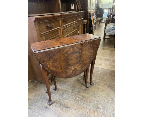 An Edwardian carved and upholstered armchair, a Chesterfield settee, a walnut drop leaf table, a dressing mirror, an oak bure