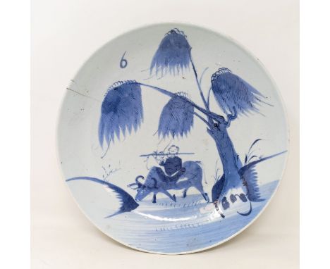 A Chinese saucer dish decorated an enlightened monk playing flute on a buffalo, late Ming, 28 cm diameterCrack to rim