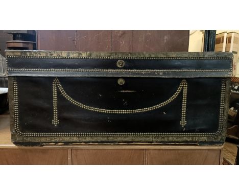 A 19th century studded leather trunk, the top initialled M G, 91 cm wide