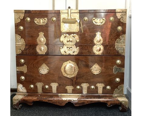 A Korean elm marriage chest, with a fall front to reveal drawers, having large brass mounts and lock,  the camphorwood interi