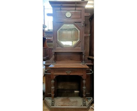 A Victorian walnut hall stand, W Walker &amp; Sons London stamp to drawer, inset with a barometer, 100 cm wide