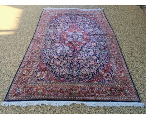 A good quality Persian silk carpet, main red border, centre with repeating foliate forms, 326 x 200 cm
