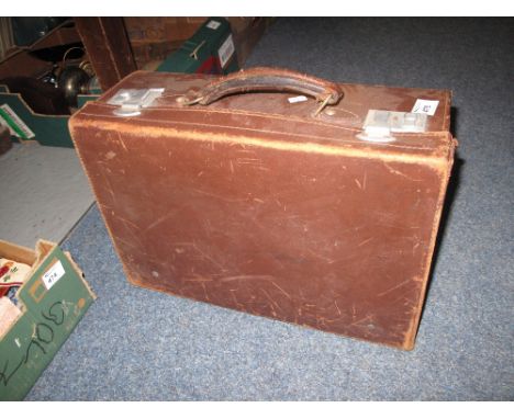 Vintage tan leather suitcase. 