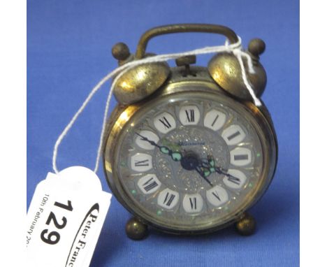 Small German gilt metal alarm clock in traditional style.
