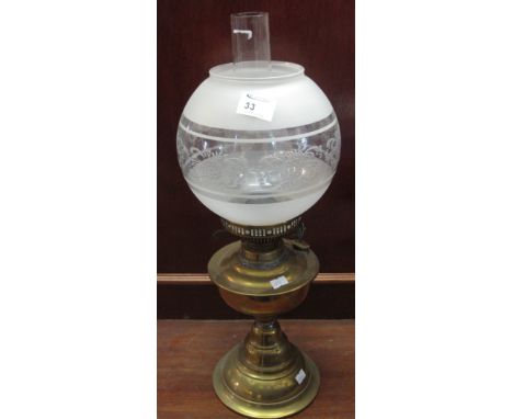 Brass double burner oil lamp with pedestal base, etched glass shade and clear chimney. 