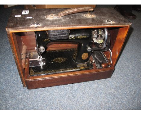 Vintage Singer sewing machine in fitted case.