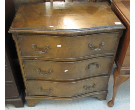 Small walnut serpentine front chest of three long drawers on bracket feet.