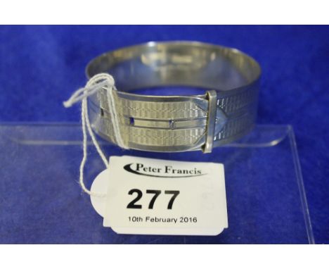 Silver wheel engraved buckle design bangle.  London hallmarks.  Makers initials H.R.T.